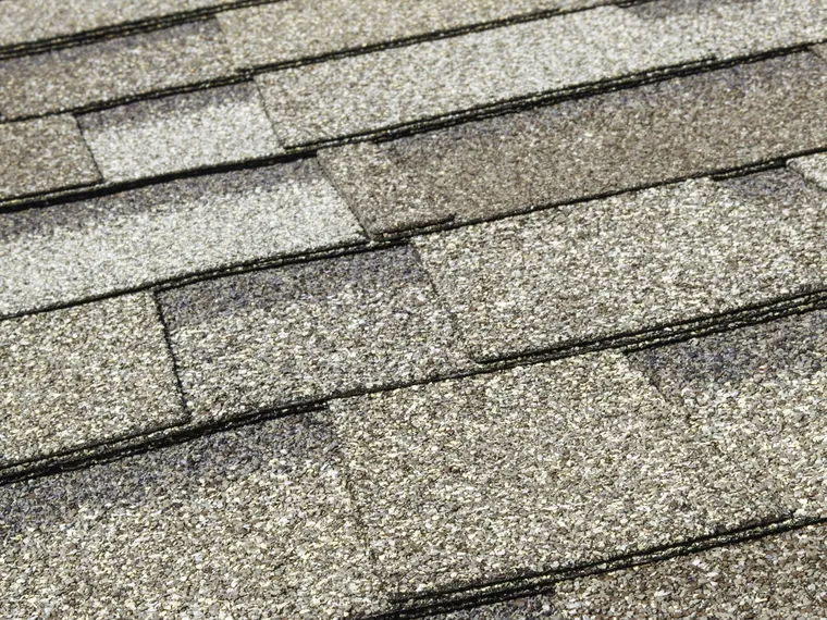 Weathered asphalt shingles after Colorado hail