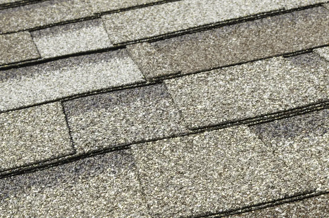 Close up of weathered grey asphalt shingles